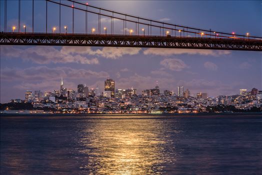 San Francisco by Moonlight - A full moon rises above the Golden Gate Bridge illuminating the San Francisco skyline.